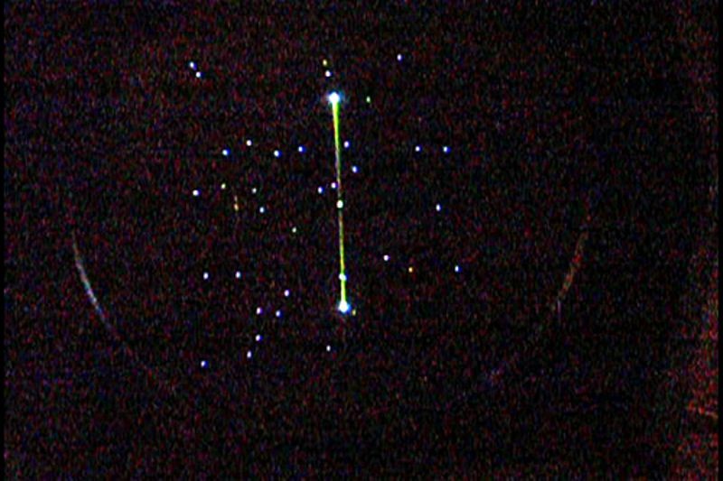 Spacewar! running on the restored PDP-1 at the Computer History Museum, showing the two ships and central star on the green phosphor CRT display